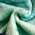 A soft, mint green flannel blanket with a textured, plush surface. The blanket features a subtle pattern.