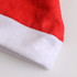 A red Santa hat with a white fluffy brim, made of soft felt material. It has a logo on it.