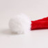 A red plush Santa hat with a fluffy white pom-pom at the tip.