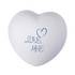 A white heart-shaped stress reliever with blue text reading "LOVE, ME". Features a smooth surface and rounded edges.