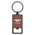 A rectangle keychain featuring a wooden texture and a circular metal ring, with a logo displayed on the front.