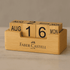 A bamboo perpetual calendar featuring wooden blocks to display the date and month, with a Faber-Castell logo.