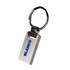 A silver keychain featuring a rectangular metal design with a keyring attachment. The keychain has a logo.