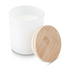A white candle in a glass container with a wooden lid. The candle is unlit and has a smooth surface.