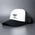 A black and white trucker cap featuring a logo on the front and a mesh back.