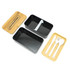 A two-layer lunch box with a bamboo lid, featuring a black inner compartment and a tray with cutlery.