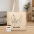 A beige tote bag featuring an illustration of a kangaroo and Australian symbols, accompanied by a crayon set.
