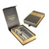 A metal ballpoint pen in brushed stainless steel, displayed in a luxury gift box with a branded logo.