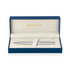 A brushed stainless ballpoint pen in a blue presentation box with a soft interior and branding visible.