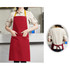 Poly-cotton canvas full bib apron in red with a yellow neck strap, featuring a front pocket. Rear view visible.