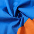 A close-up of fabric showcasing vibrant blue and orange colours, featuring smooth texture and folds.
