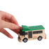 A hand adjusts a green and beige building block bus model, featuring wheels and a roof sign.