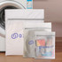 Three mesh laundry bags in white and grey, featuring a logo, arranged beside a washing machine.
