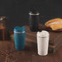 A drink bottle set featuring stainless steel travel mugs in blue, black, and white, with a textured design and lids. A drink bottle set featuring stainless steel travel mugs in blue, black, and white, with a textured design and lids.