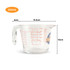 A clear glass baking measuring jug with graduated markings and a logo, holding up to 500ml.