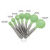 A set of green measuring spoons with stainless steel handles, featuring seven different sizes on a metal ring.