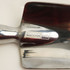 A shiny metal garden spade with a reflective surface and a sturdy handle. It features a logo on the blade.
