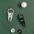A golf divot tool in silver and a black bottle opener, accompanied by a golf ball and several markers. Both tools feature logos.