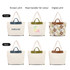 A canvas bag with leather handles in cream, featuring various designs on the front and back. Logo present.