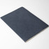 A notebook with a textured navy blue cover, featuring a plain design and an unembellished interior.