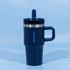 A drink bottle featuring a navy blue exterior, double wall insulation, and a secure lid with a straw.