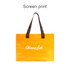 A clear tote bag in vibrant orange with black handles featuring logos. A clear tote bag in vibrant orange with black handles featuring logos.