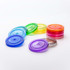 A set of colourful plastic lids in various shades, including blue, green, yellow, orange, pink, and purple.