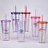 A set of six transparent plastic cups with lids and straws in purple, pink, and orange, featuring various logos.