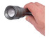 A gunmetal torch with a textured grip held in a person's hand, featuring a round lens at the front.