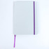 A grey notebook with a purple elastic band and ribbon marker, featuring a dotted design on the cover.