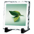 A photo frame featuring a green leaf image, set on a black stand with a textured white stone border.