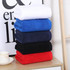 A stack of gym towels in white, blue, dark blue, black, and red, neatly folded and organised. A stack of gym towels in white, blue, dark blue, black, and red, neatly folded and organised.