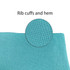 A close-up of the rib cuffs and hem of a blue polyester fabric.