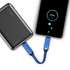 A black power bank with blue charging cable connected to a smartphone, displaying an 88% battery charge.