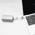 A silver 60W 3-In-1 aluminium charging cable connected to a laptop, featuring a logo on the cable.