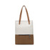 A convertible canvas backpack to tote bag in cream and brown with two tan straps and a zippered front pocket.