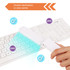 A portable UV steriliser in white is held over a white keyboard, emitting blue light for disinfection.