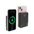 A magnetic wireless power bank in black, next to a smartphone displaying a charging indicator. Features a digital power level display.