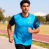 A blue and navy 100% polyester sublimated tee shirt with a logo, modelled by a man jogging outdoors.