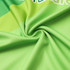 A close-up of a vibrant green fabric with a textured weave, featuring a small logo.
