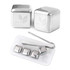 A stainless steel ice cube set featuring four silver cubes and a pair of tongs, presented in a white tray.