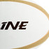 A white rugby ball with a textured surface and a brand logo featuring black and gold accents.