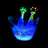 A clear LED ice bucket filled with ice and two bottles, illuminated with colourful LED lights.