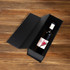 A drink bottle neatly placed inside a black foldable magnetic wine box, showcasing its sleek design.