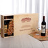 A wooden gift box for six wine bottles, featuring a natural finish with decorative wood shavings and a glass.