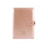 A rose gold notebook with a clasp, featuring a logo on the front cover. Sized for office use.