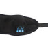 A black Bluetooth eye mask with built-in speakers and control buttons. It features a soft, plush fabric.