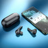 Black active noise-cancelling TWS earbuds and their charging case beside a smartphone with a music player interface.