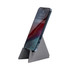 A grey phone stand displaying a smartphone in an upright position, featuring a simple triangular design.