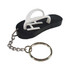 A custom moulded flash drive shaped like a black flip-flop with a white thong and attached keychain.